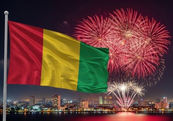 vibrant display of fireworks lights up night sky over cityscape, highlighting prominent guinea flag. national celebration, guinea independence day, holiday. greeting card, event promotion.