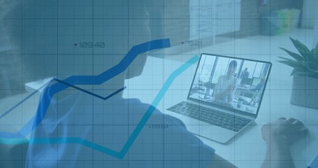 Employee joining meeting in office, with laptop showing four colleagues, succulent, gridded graphs
