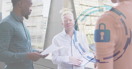White-shirted woman discussing security on office balcony, holding open folder and padlock graphic