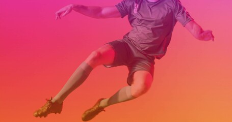 Jumping male soccer player performing kick in photography studio, with number 8 jersey and cleats