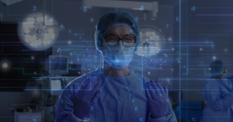 Standing Chinese surgeon wearing scrubs, gloves and mask in operating room, with digital overlays
