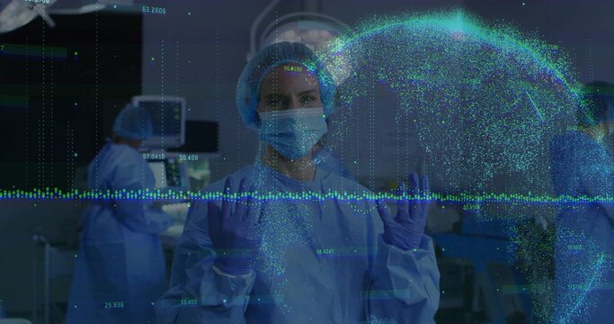 Gowned surgeon manipulating holographic globe in operating room, with monitors and instrument tray