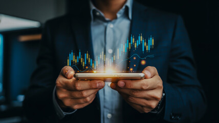 Businessman holding smartphone with glowing financial stock market graph overlay