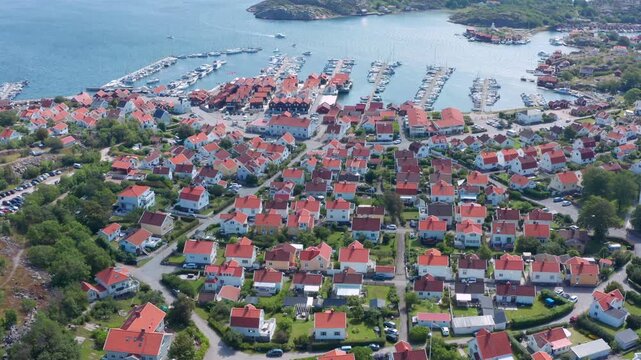 Sweden old community at ocean on Swedish West coast from above. Well maintained white wooden houses at harbour of Bohus Malmon. Sunny day in summer