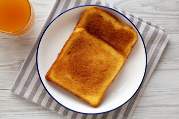 Homemade American Cinnamon Toast with Butter and Orange Juice, top view.