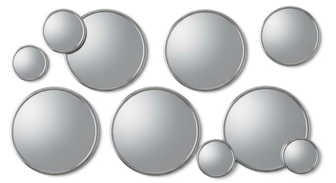 Abstract composition of various sized silver metallic circles with reflective surfaces and chrome frames, arranged on a clean white background, creating a modern design with ample copy space. - Powered by Adobe