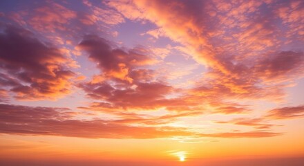 Fototapeta premium A vibrant and colorful sunset or sunrise sky with dramatic clouds painted in hues of orange, pink, and purple, creating a breathtaking natural backdrop.