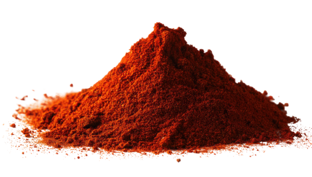 A conical pile of vibrant red spice powder sits atop a textured surface