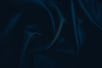 Dark Fabric with Elegant Folds. Abstract background of black silk fabric with soft, wavy folds.