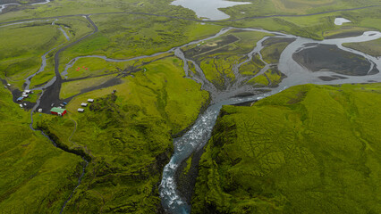 Aerial View of Icelandic River, Waterfall, and Red Roofed Building