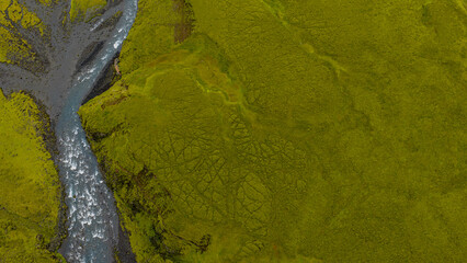 Aerial View of a Winding River in Moss Covered Icelandic Landscape
