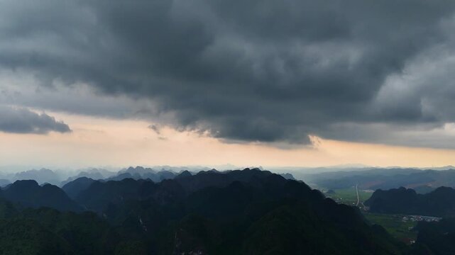 Storm Clouds Looming Over Karst Valley with Patchy Rain