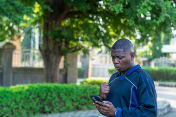 Fototapeta premium African millennial browsing smartphone