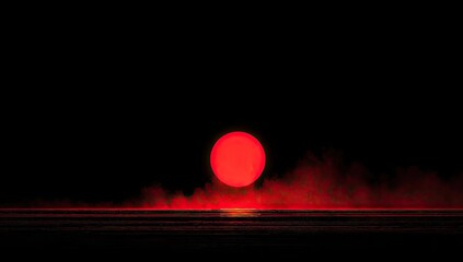 Glowing crimson sun sinks into a dark misty horizon.