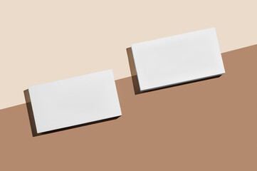Two white rectangular podium or boxes with shadow on diagonally divided yellow brown background.