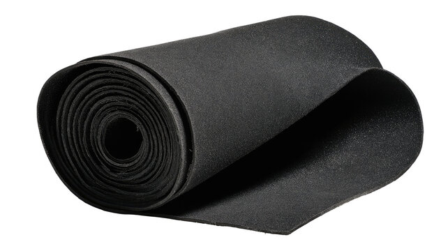 Rolled black filter material, studio shot, dark background, industrial use