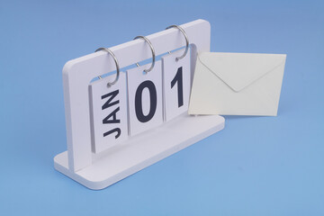 January, 1 on calendar and envelope on blue background.