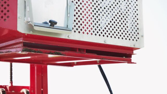 Hydraulic container door closing on combine tractor harvester for wallnut and hazelnuts on agriculture farm, slow motion