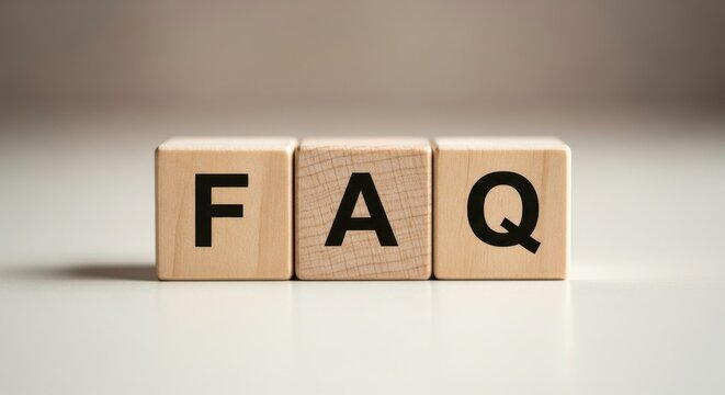 Three wooden blocks displaying the letters f a q in black against a neutral background