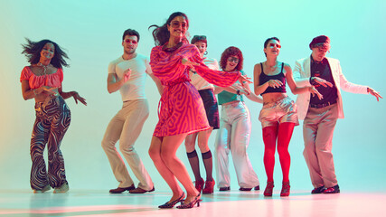 Dancing friends moving in sync at retro inspired party celebration. Concept of youth culture, music...