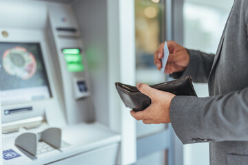 Man Using ATM Withdraws Cash Holding Card and Wallet in Business Attire