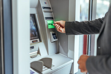 Hand Inserting Card Into ATM for Banking Transaction in Modern Financial Setting