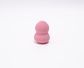 Isolated pink beauty blender sponge for makeup application.