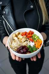 bibimbap on a plate in the hands of a girl