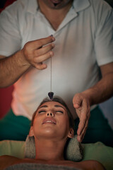 young attractive Caucasian female enjoy treatment of alternative medicine with plumb line