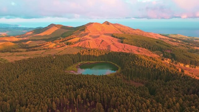 Hills, Forest and Lake Lagoa do Canario at Sunset. Azores, Sao Miguel Island, Portugal. Aerial View. Drone Moves Forward