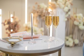 two glasses of champagne on the table in a restaurant, wedding day