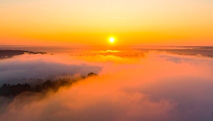 Obraz premium Sunrise over a misty landscape