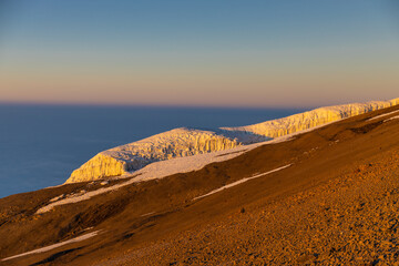 Mount Kilimanjaro hiking trail, way to the summit of mount Kili the highest volcano in Africa, Tanzania. View from top of mountain Kilimanjaro. Snow and glacier on top of Kilimanjaro, Mount Kili