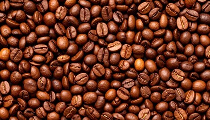 Fototapeta premium Close-up view of numerous roasted coffee beans, showcasing rich brown tones and intricate textures.