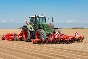 Tractor with front tiller and rotary hiller forming ridges for potato cultivation in the field - 1060