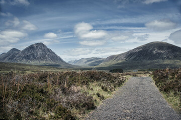 Fototapeta premium Vibrant Glencoe Mountain Resort campsite in Scotland surrounded by mountains