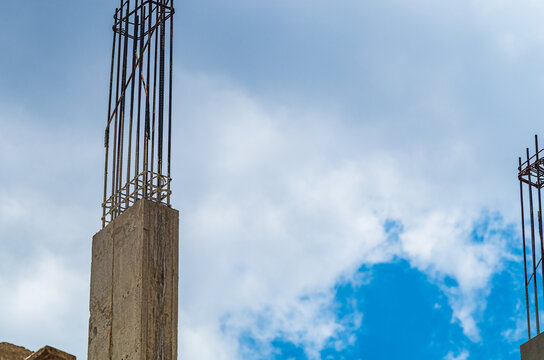 Fragment of monolithic supporting frame of multi-storey building under construction using technology of pouring high-quality liquid concrete to removable formwork, rod structure of steel reinforcement