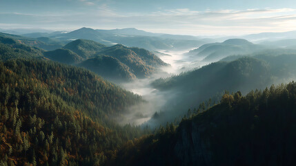 Fototapeta premium Misty Mountain Panorama: An aerial perspective unveils a majestic mountain range, shrouded in an ethereal mist that gently caresses the forested slopes, creating a tranquil and breathtaking landscape