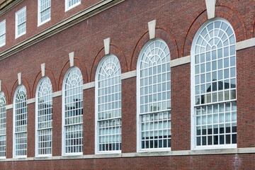 Elegant arched windows on a historic red brick building in Cambridge, Massachusetts, USA
