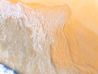 Aerial view sandy beach and waves Beautiful tropical sea in the morning summer season image by Aerial view drone shot, high angle view Top down beach sand