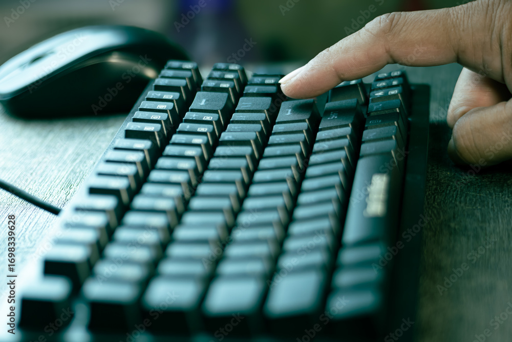 Aufkleber close-up of a finger pressing the enter key on a black computer keyboard, symbolizing technology, co