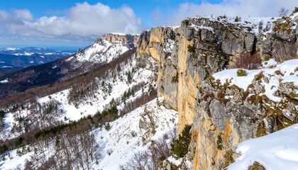 Snowy mountain range with a sheer cliff face