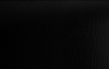 Naklejka premium Black silk fabric texture with smooth folds and shiny surface, elegant luxury background for design and decoration.