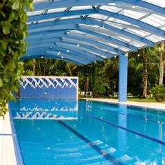 Tropical indoor pool area under a blue canopy