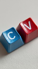 Two colorful keycaps with letters c and v isolated on white background