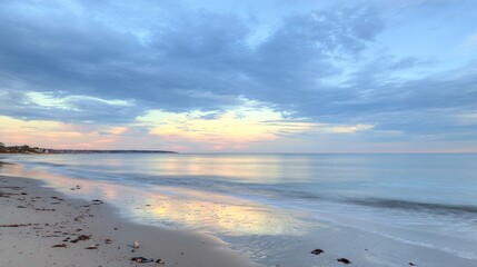 Obraz premium Soft Pastel Sunset Over a Calm Ocean Beach: Gentle Pink & Lavender Sunset Glow, Serene Beach with Calm Waves—Tranquil Coastal Scene of Pastel Hues at Dusk