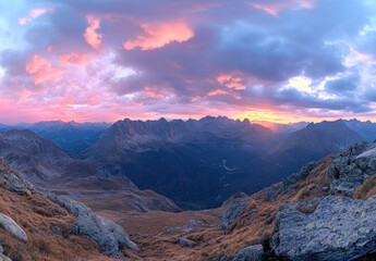 A breathtaking panoramic view of the Dolomites mountain range at sunset, showcasing its majestic peaks and colorful sky in autumn.