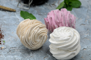 dessert marshmallows multicolored on a gray background macro photo