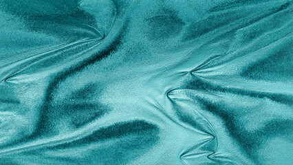 Blue foil texture with shiny metallic surface and wrinkled pattern, abstract luxury background for design and decoration.