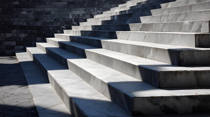 A modern concrete staircase with sharp angles and contrasting light and shadow, creating a dramatic and abstract architectural pattern.
